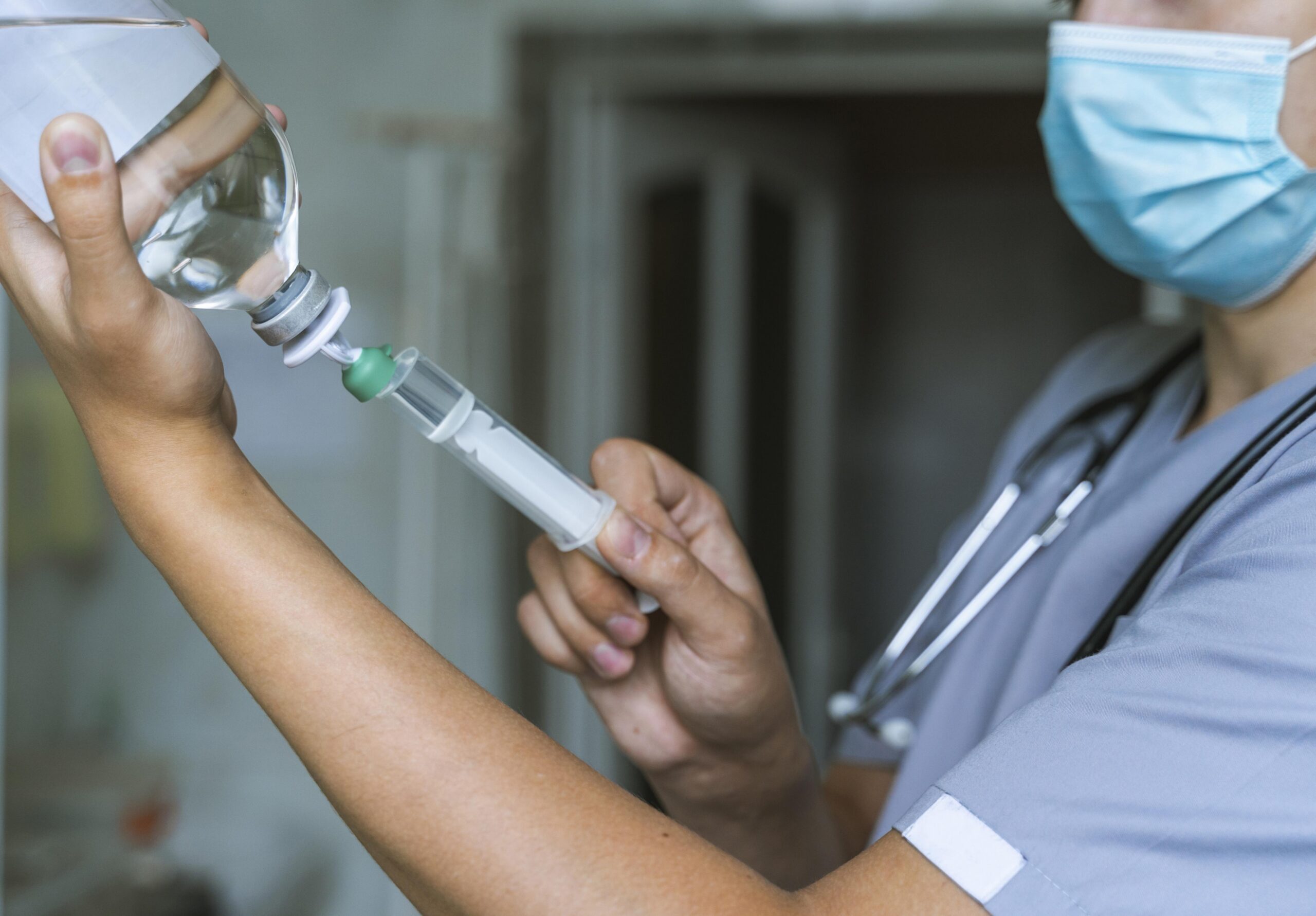 side-view-doctor-filling-up-syringe-with-medicine